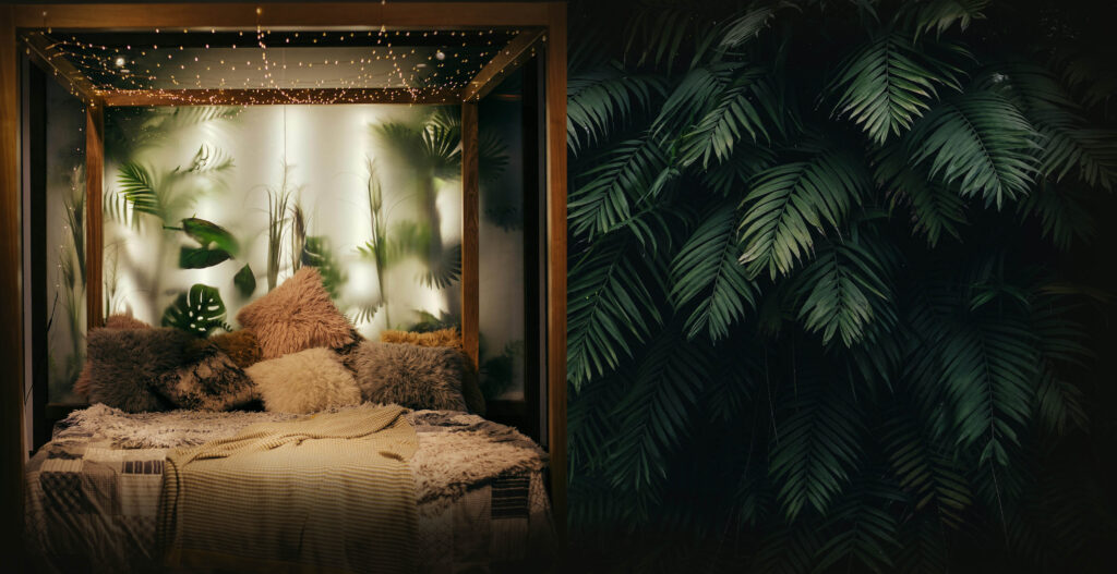 Green tropical boho wallpaper and lush decor bedroom with fairylight canopy